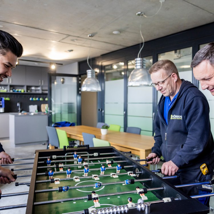 Männer spielen zusammen Kicker